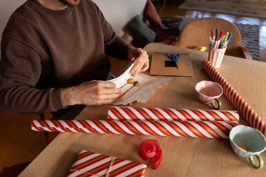 Man wrapping small gifts