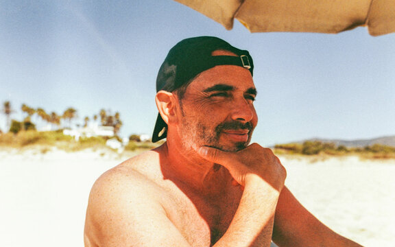 Confident Man Portrait on the Beach Looking to the Horizon