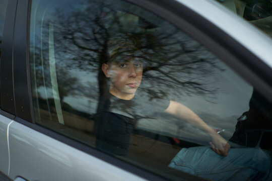 portrait of kid sitting in a car