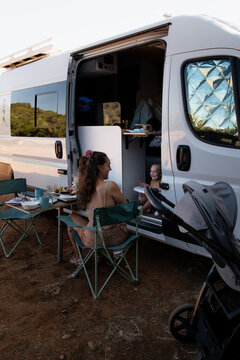 Woman and baby enjoying travel motorhome nomadic lifestyle