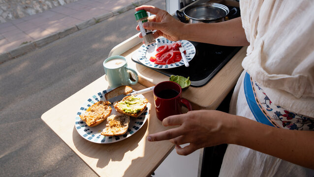 Woman preparing healthy breakfast inside camper van