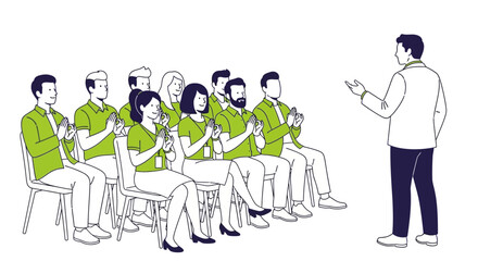 A man stands and gestures to a group of people sitting in chairs wearing green shirts and clapping.