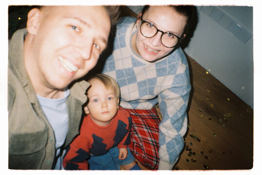 Family selfie with parents and toddler at home in winter