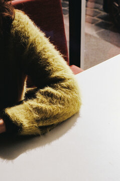 Film photo of a Close-up of Green Fuzzy Sweater Over a Table