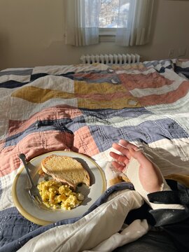 Injured woman eats breakfast in bed