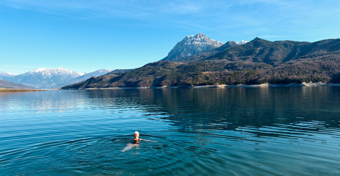 Swimmer Enjoying Clear Water in Mountain Lake During Daytime