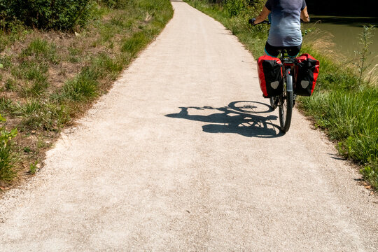 Cyclist Shadow on Gravel Trail