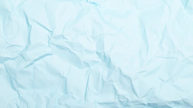 Crumpled paper texture viewed from above with folds and creases in a close-up shot