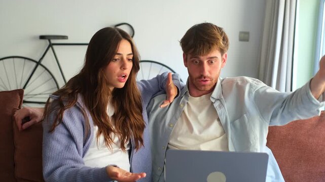 Millennial couple annoyed by stuck laptop or online news sitting together on sofa, frustrated young angry customers confused by computer problem feeling perplexed or puzzled about email message
