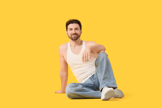 Bearded man in casual clothes on yellow background. Body positive concept