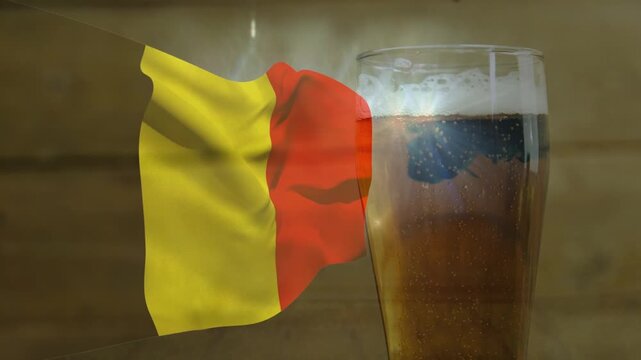 Wind-driven yellow red flag billowing right, overlapping beer glass and causing bright reflections