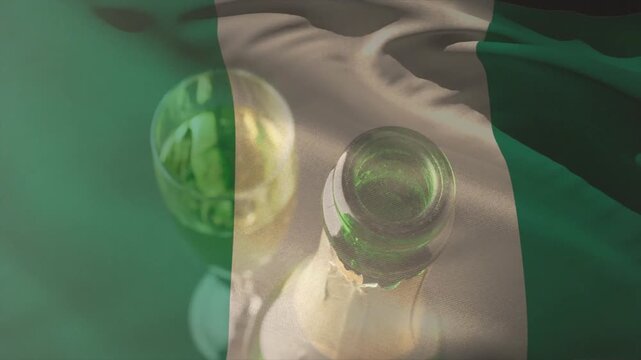 Top ripple starting, sheer flag rippling across green bottle and glass adding soft highlights