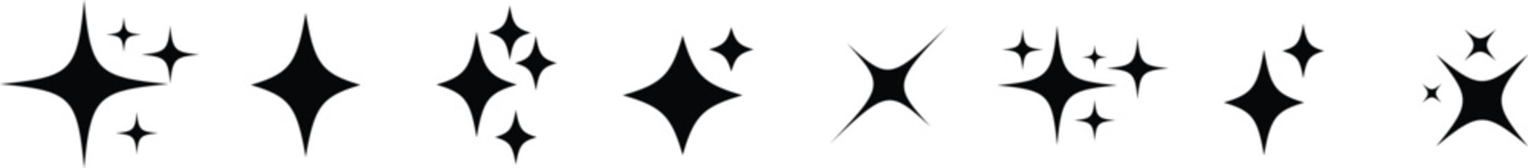 A horizontal array of various black four pointed sparkle shapes and shining star icons on white © Design_a2z