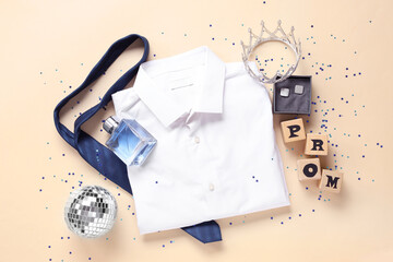 Male shirt with tie, crown and word PROM on beige background © Pixel-Shot