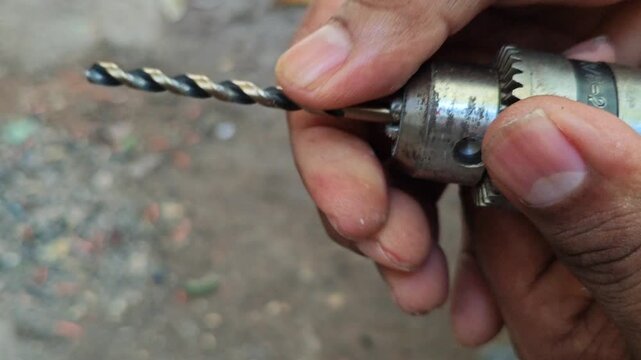 Placing a drill bit into a manual drill chuck