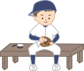 帽子を後ろに向きにかぶり、野球のグローブのお手入れをする男の子