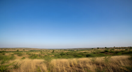 Natural rural landscape of India with dry grass rolling hills an
