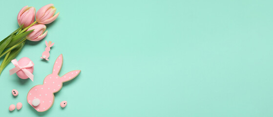 Obraz premium Composition with Easter eggs, decorative bunnies and tulip flowers on turquoise background