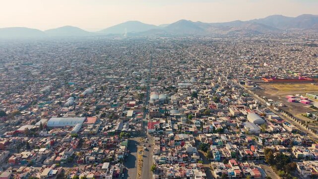 Aerial drone shot of densely packed homes in Ecatepec at golden hour