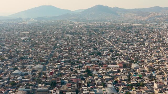 Drone footage showing Ecatepec&rsquo;s dense residential rooftops in warm sunset light