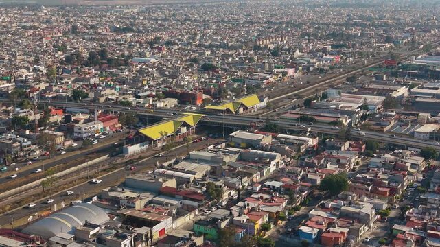 Low drone pass through Ecatepec neighborhood streets, dense rooftops and motion