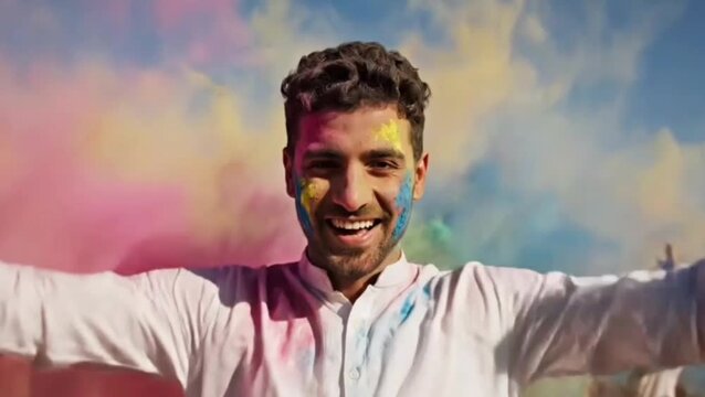Slow motion portrait of smiling Arab man enjoying Holi festival while people throwing paint powder at him
