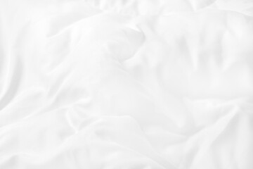 Obraz premium Close up top view of white bedding sheet and wrinkle messy blanket in bedroom after wake up in the morning.