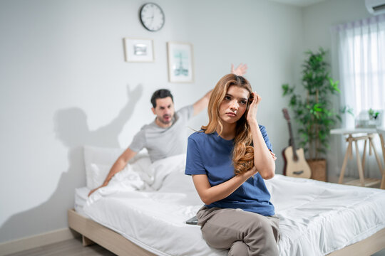 Stressed woman and aggressive man couple screaming at each other in house. 