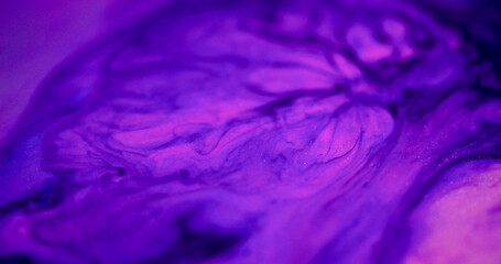 Neon paint defocused. Blob spill. Purple pigment drop dissolving on pink blue color fluid. Watercolor stream mix abstract background.
