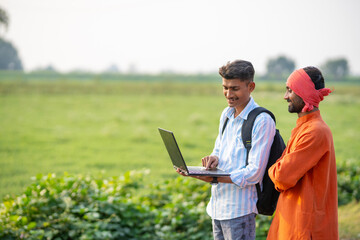 indian farmer with banker or agronomist at agriculture field