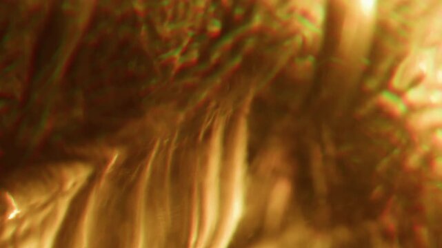 Defocused flicker background. Optical glow. Yellow orange color warm rainbow glare shadow reflection on art illuminated abstraction.