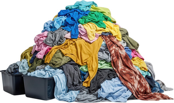 A large pile of colorful unwashed clothes overflows from two black laundry baskets creating a messy heap of fabric dirty textile domestic household chore task sorting clean