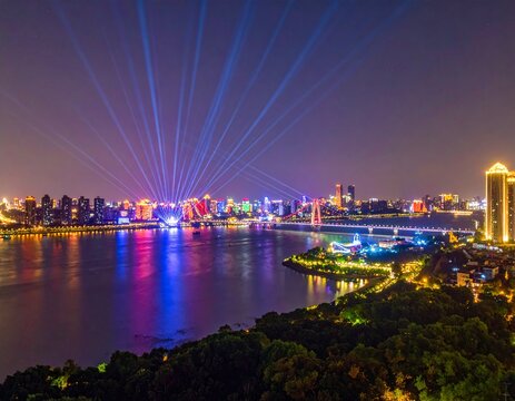 Nighttime Cityscape Illuminated with Vibrant Lights Reflecting on the Water.