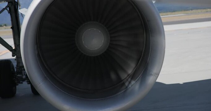 Jet Engine Turbine Blades Rotating While Aircraft Waits on Tarmac