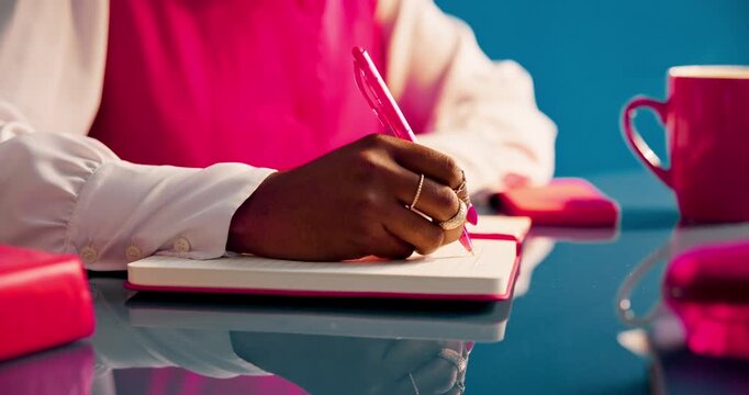 Business woman, writing and hands in studio for planning, productivity and project management. Aesthetic, journalist and employee with notebook, research and creative publisher on blue background