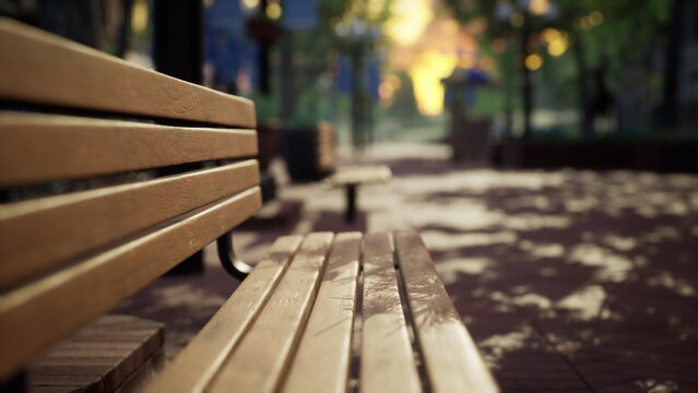 A rustic wooden bench sits quietly in a serene park, surrounded by lush greenery. Soft golden light filters through the trees, creating enchanting shadows on the path.
