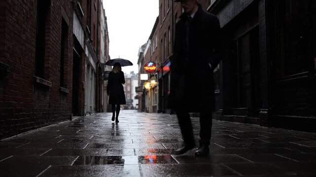 Person Walking Down Dark Alleyway in Rain.