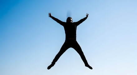 Man jumping with joy against blue sky with cityscape