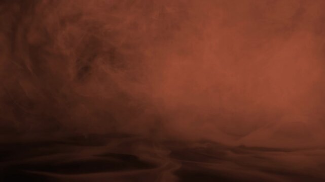 Cinematic orange fire smoke with atmospheric mist and wispy textures on black background for action movie overlays