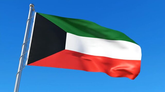 The Kuwaiti flag flutters above a clear blue sky. 