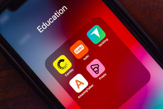 Mexico City, MEXICO - Apr 16 2025 : Close-up of smartphone showing Education folder with language tutoring apps italki, Cambly, Preply, Verbling and AmazingTalker on red gradient.