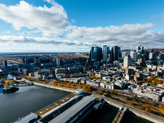 Obraz premium Aerial view of Montreal Old Port, downtown, historic buildings and waterfront under blue sky. g.