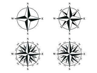 Set of black and white compass rose icons in different styles, including 4-point, 8-point, and 16-point variants with cardinal and intercardinal directions. Clean vector navigation symbols isolated © Hannet