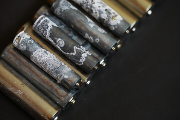 Close-Up of Corroded Batteries: Environmental Impact and Recycling Challenges in Stock Photography