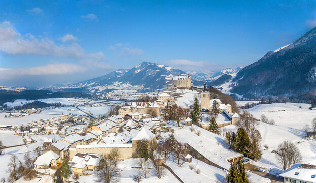 Panorama aerial image of the medieval town Gruyeres with Castle on the hill top of Alps in winter. It is one of the most popular tourist destionations.