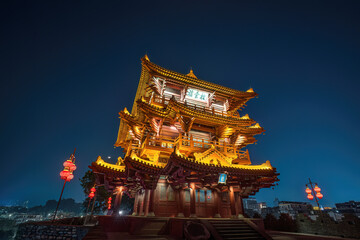 Moonlit Chinese Pagoda Tower at Night with Golden Lights