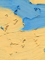 Layers of yellow and blue acrylic paint showing texture and movement during an art session on a canvas in a creative studio space