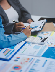Auditor and accountant team working in office, analyze financial data and accounting record with calculator. Accounting company provide finance and taxation planning for profitable cash flow. © Phanphen