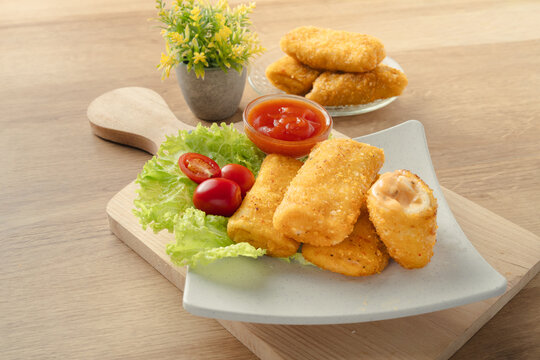 Crispy Fried Risoles Mayo with Savory Filling Served with Chili Sauce and Fresh Vegetables