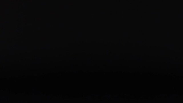 White Ping Pong Ball Moving Across a Dark Grid Background